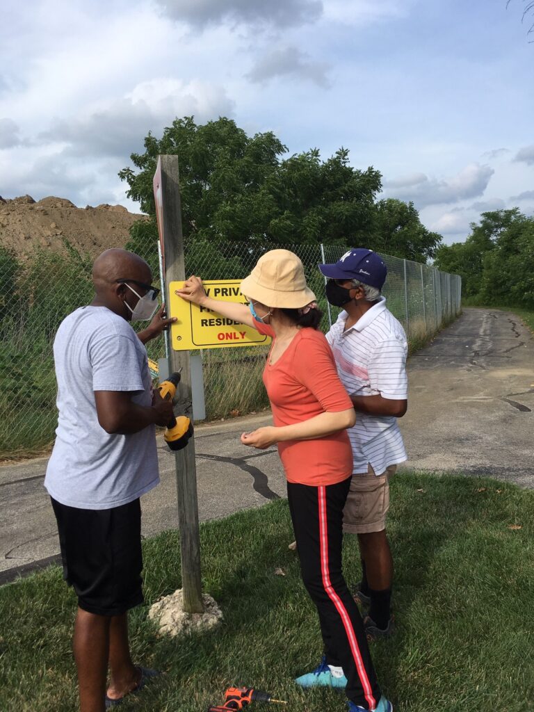 Sunder, Charles, Yan Ping, Aloke, and XiaoRui fixing the Signs for the Community